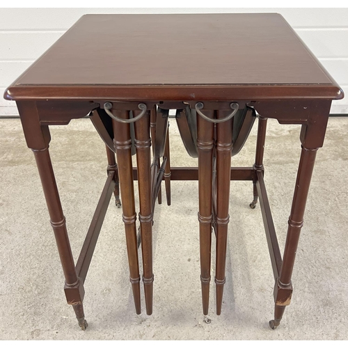 1394 - A vintage dark wood nest of 3 tables with 2 small drop leaf folding tables and larger square shaped ... 