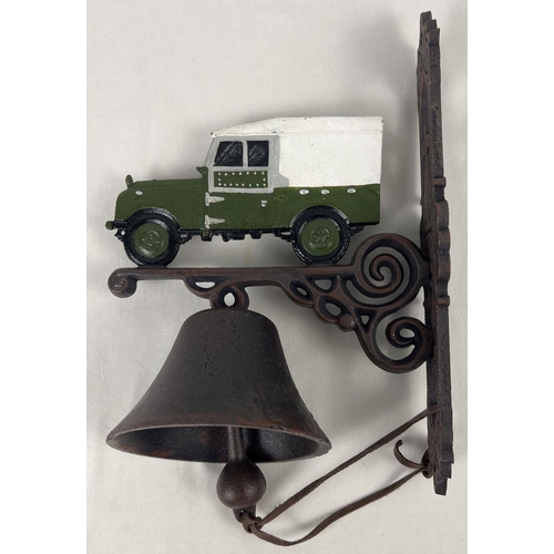 1162 - A wall mountable painted cast iron garden bell with painted Land Rover detail and leather strap bell... 