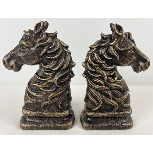 1163 - A pair of bronze effect cast iron horse head figures. Each approx. 24cm tall and weighs 2.1kg.