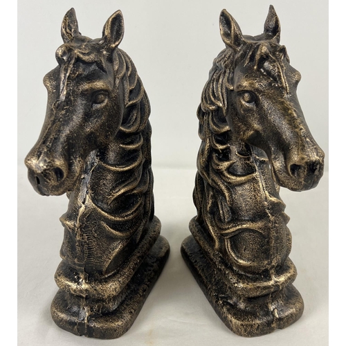 1163 - A pair of bronze effect cast iron horse head figures. Each approx. 24cm tall and weighs 2.1kg.