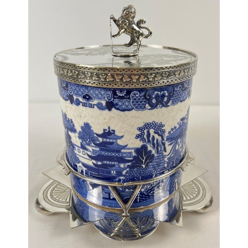 1192 - A Victorian ceramic lidded biscuit barrel in a decorative silver plated stand. Barrel with printed b... 