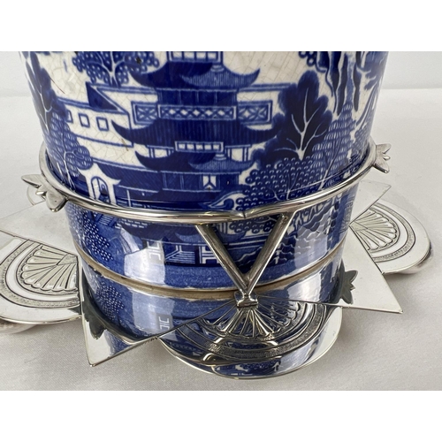 1192 - A Victorian ceramic lidded biscuit barrel in a decorative silver plated stand. Barrel with printed b... 