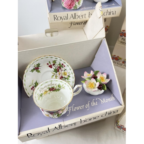 1193 - A full set of 12 boxed Royal Albert 'Flower of the Month' cup & saucer sets each with a flower displ... 