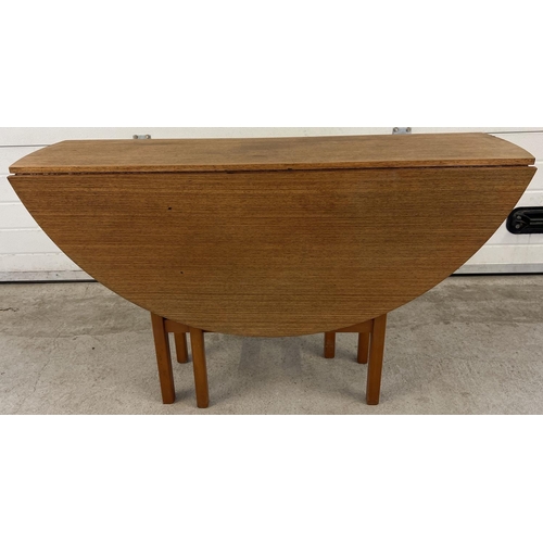 1395 - A vintage 1970's teak drop leaf slim dining table with gateleg supports. Approx. 74.5cm tall x 122cm... 