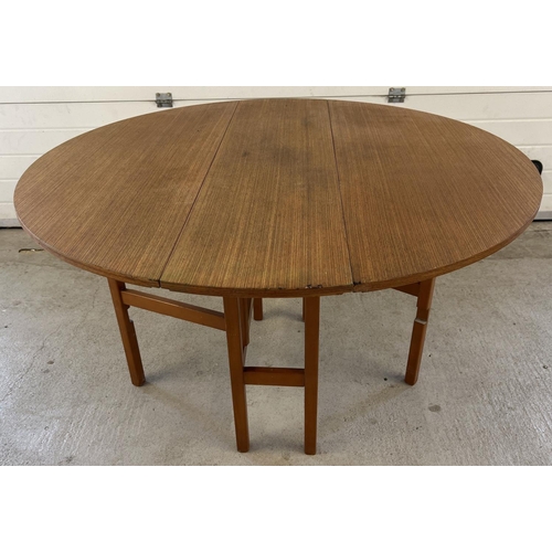 1395 - A vintage 1970's teak drop leaf slim dining table with gateleg supports. Approx. 74.5cm tall x 122cm... 