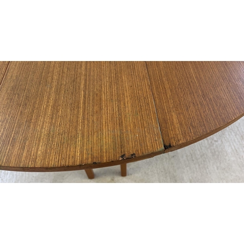 1395 - A vintage 1970's teak drop leaf slim dining table with gateleg supports. Approx. 74.5cm tall x 122cm... 