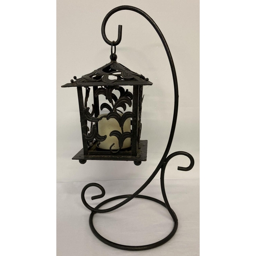 1383 - A decorative cast iron, free standing, garden candle lantern and stand. Approx. 47cm tall.