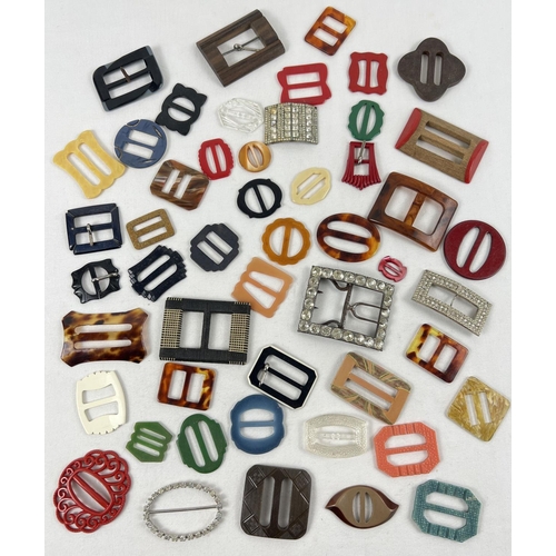 1345 - A collection of 50 vintage buckles in varying colours, sizes and designs. To include wood, diamante ... 