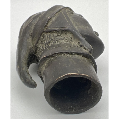 1172 - A vintage hollow bronze walking cane handle modelled as a head. Approx. 8.5cm long.