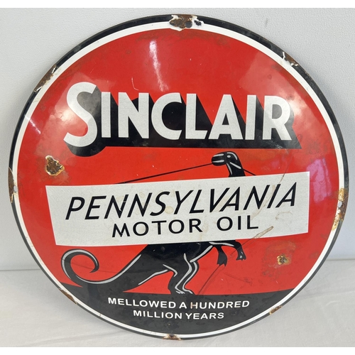 1173 - A circular shaped convex enamelled wall sign for Sinclair Pennsylvania Motor Oil. Approx. 29.5cm dia... 