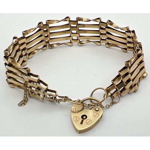 1092 - A 9ct gold 5 bar gate bracelet with heart shaped padlock clasp and safety chain. Fully hallmarked to... 