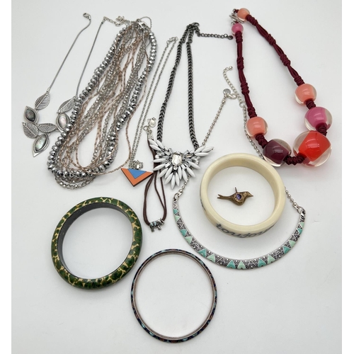 1093 - A small collection of costume jewellery necklaces and bangles. To include white metal enamel bangle,... 