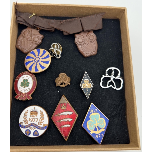 1357 - A collection of vintage Girl Guiding brass and enamel badges. Lots includes group leaders ribbon, 10... 