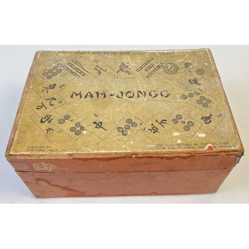 51 - A boxed 1920's Chad Valley Mah-Jong set in original red card box. A complete set of 144 wooden tiles... 