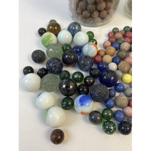 61 - A collection of assorted vintage glass, clay and stone marbles. In varying sizes & colours.