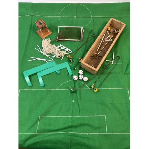 65 - A collection of Subbuteo goal keepers on wires and assorted accessories. To include green felt pitch... 