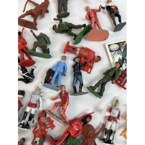 21 - A tin of assorted vintage painted lead and plastic soldiers, cowboys and figures. To include Britain... 