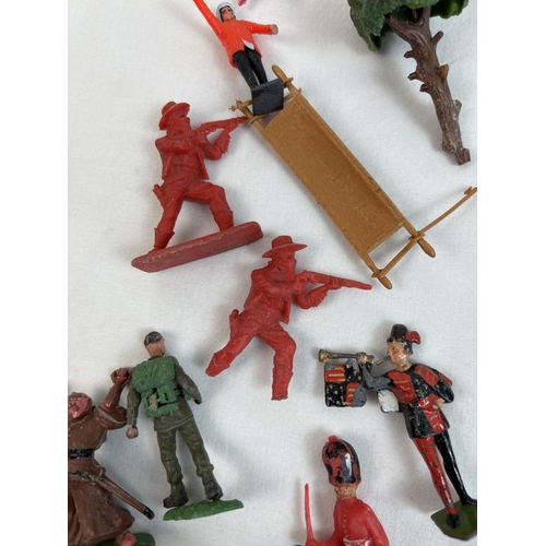 21 - A tin of assorted vintage painted lead and plastic soldiers, cowboys and figures. To include Britain... 