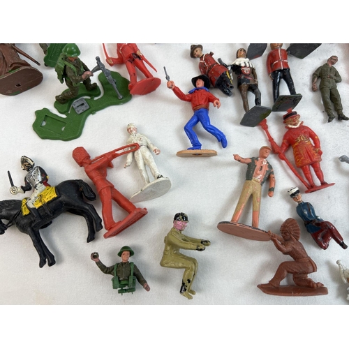 21 - A tin of assorted vintage painted lead and plastic soldiers, cowboys and figures. To include Britain... 