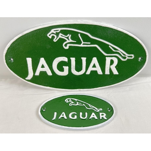 1297 - 2 oval shaped painted cast iron Jaguar wall plaques, in green and white. Largest approx. 34.5cm long... 