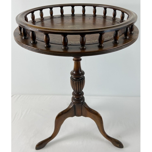 1426 - A vintage dark wood wine table with tripod feet, turned pedestal and galleried top. With brown leath... 