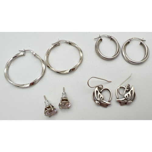 1012 - 4 pairs of silver earrings. A pair of twist design hoops, a pair of clear stone set studs, a pair of... 