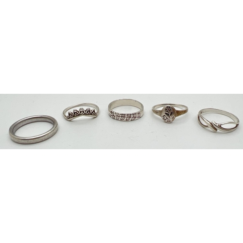 1013 - 5 silver band and dress rings. To include band ring with engraved leaf design, tiara style ring and ... 