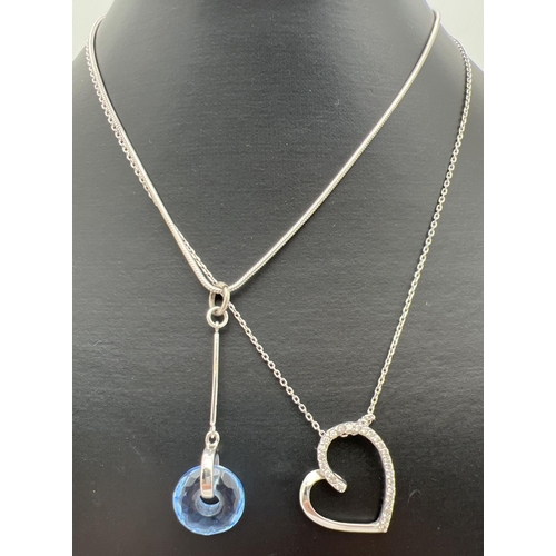 1014 - 2 silver necklaces. A clear stone set floating heart on a 16