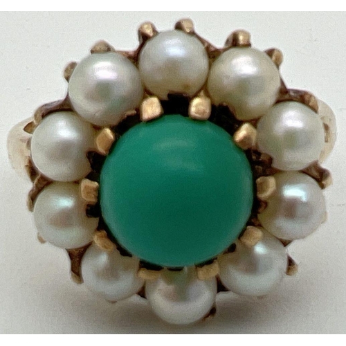 1015 - A vintage 9ct gold dress ring set with turquoise and pearls. Central round cabochon of blue turquois... 