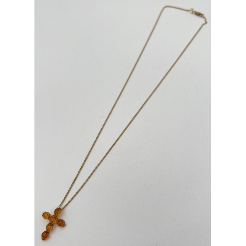 1020 - A boxed 9ct gold amber set cross pendant on an 18