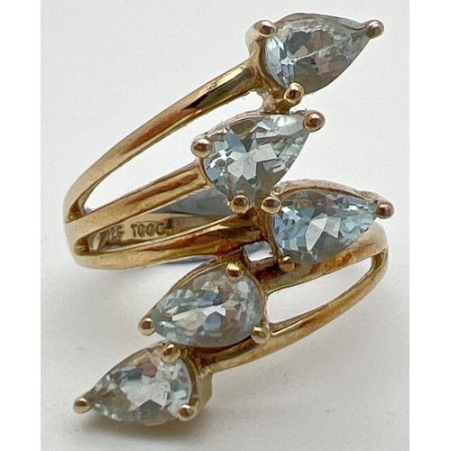 1025 - A silver gilt spray design dress ring set with 5 teardrop cut pale blue topaz stones, by The Genuine... 