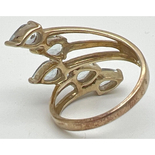 1025 - A silver gilt spray design dress ring set with 5 teardrop cut pale blue topaz stones, by The Genuine... 