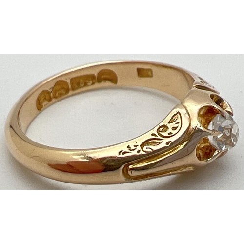 1003 - An Victorian style 15ct gold claw set single diamond dress ring. Floral detail to shoulders. Approx.... 