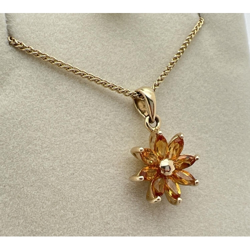 1030 - A 9ct gold flower design pendant set with 8 marquise cut citrine stones. On an 18