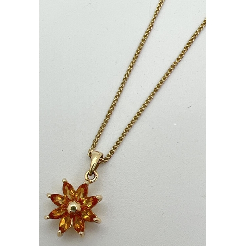 1030 - A 9ct gold flower design pendant set with 8 marquise cut citrine stones. On an 18