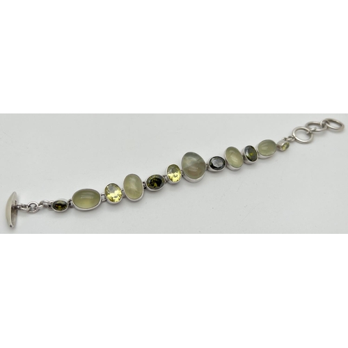 1041 - A modern design stone set bracelet with T Bar style clasp. Bracelet set with 7 bezel set faceted lig... 