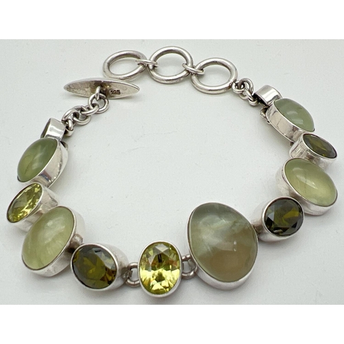 1041 - A modern design stone set bracelet with T Bar style clasp. Bracelet set with 7 bezel set faceted lig... 