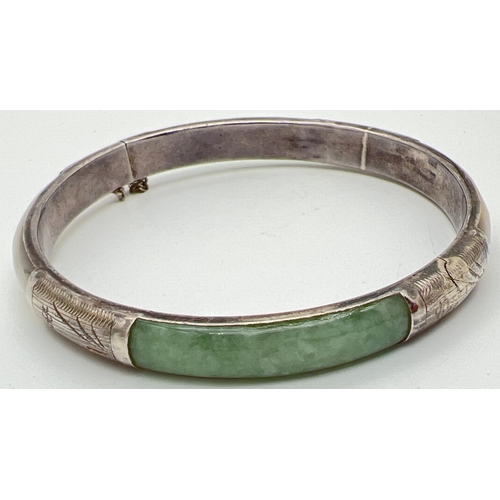 1048 - A silver, mother of pearl and jade panel bangle with push clasp & safety chain. Silver mark to clasp... 