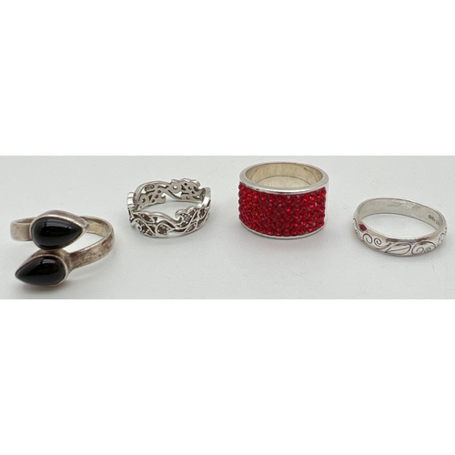 1053 - 4 silver dress rings in varying conditions. To include a onyx set crossover style ring and a band ri... 