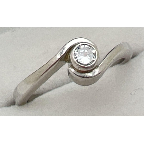 1057 - A boxed twist design platinum .10ct diamond solitaire ring by Chapelle. Tests as platinum, shows sig... 