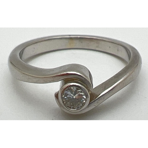 1057 - A boxed twist design platinum .10ct diamond solitaire ring by Chapelle. Tests as platinum, shows sig... 