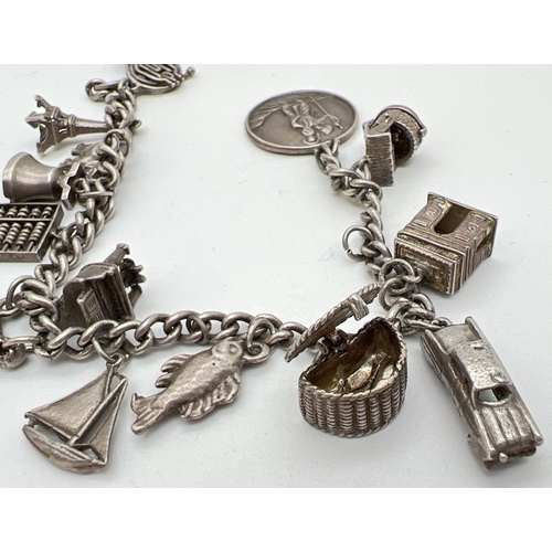 1058 - A vintage white metal curb chain bracelet with 15 silver and white metal charms. No clasp to bracele... 