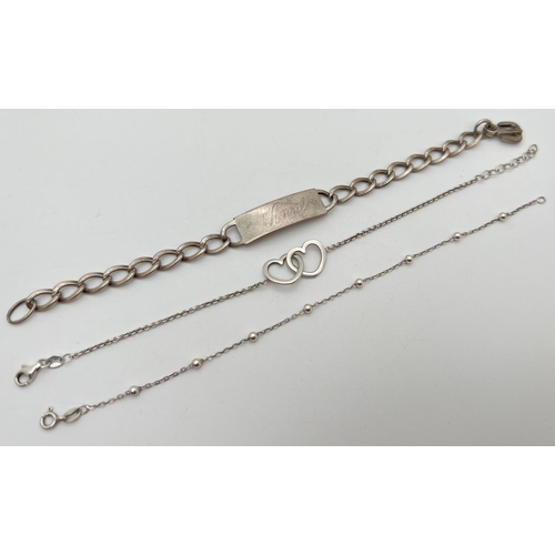 1061 - 3 silver bracelets. A double floating heart and belcher chain bracelet, a ball and chain bracelet an... 