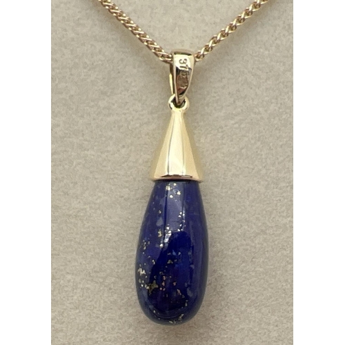 1064 - A modern design Lapis Lazuli and 9ct gold teardrop pendant. On an 18