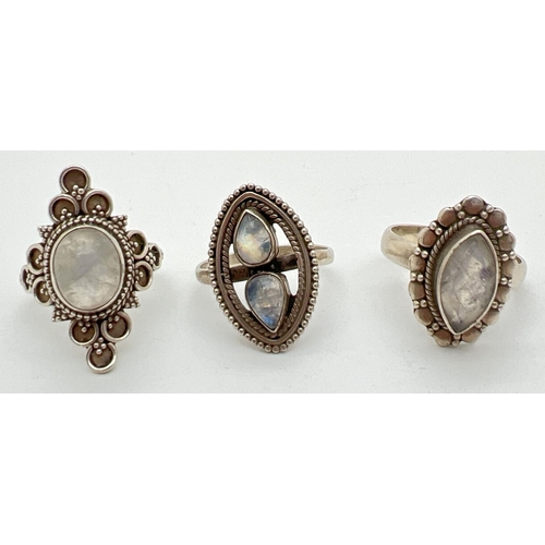 1065 - 3 ethnic style dress rings, all with decorative mounts and set with moonstones. Sizes M, N and N½. T... 