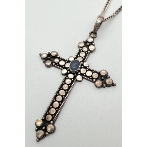 1006 - A large modern design cross pendant with circle decoration, set with an oval opal stone on a 20