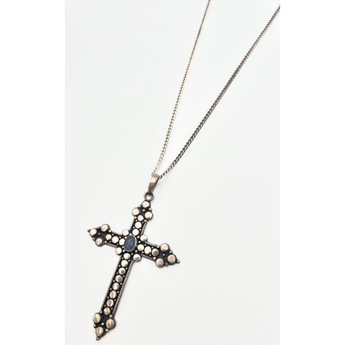 1006 - A large modern design cross pendant with circle decoration, set with an oval opal stone on a 20