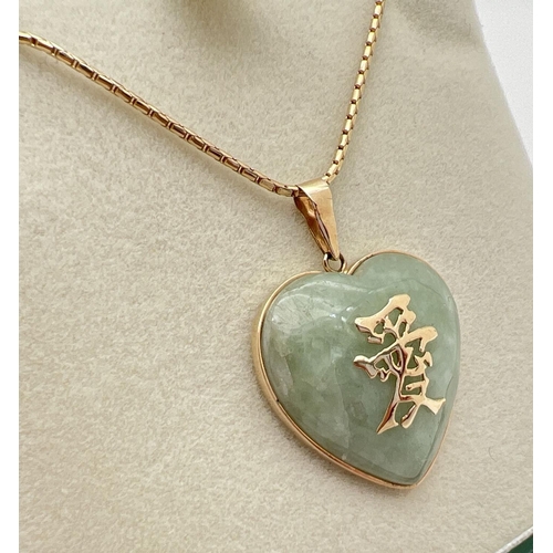 1069 - A 9ct gold heart shaped pendant set with pale green jade, with 9ct gold Chinese characters to front.... 