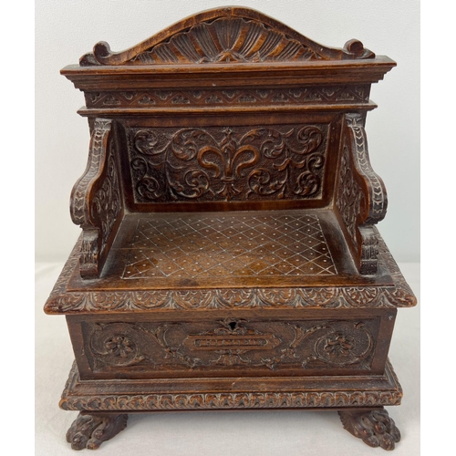 1309 - A late Victorian sewing box modelled as a highly carved monks bench with claw feet. With ornately ca... 