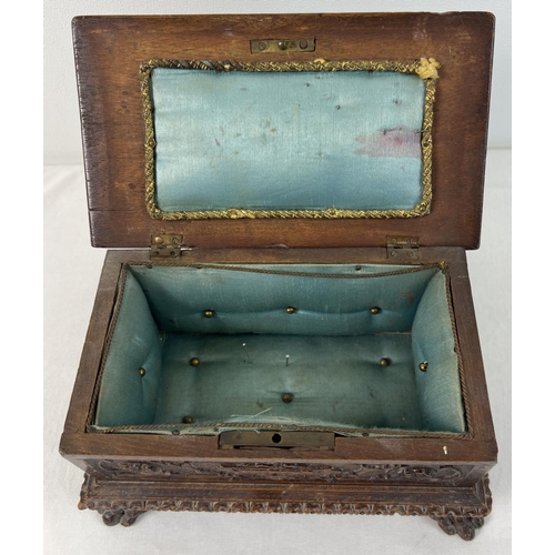 1309 - A late Victorian sewing box modelled as a highly carved monks bench with claw feet. With ornately ca... 